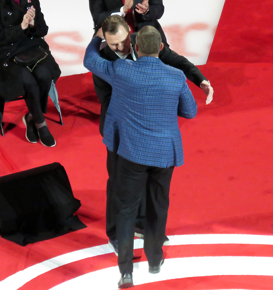 Sergei Fedorov and Steve Yzerman hug before Fedorov speaks at Fedorov's jersey retirement ceremony.