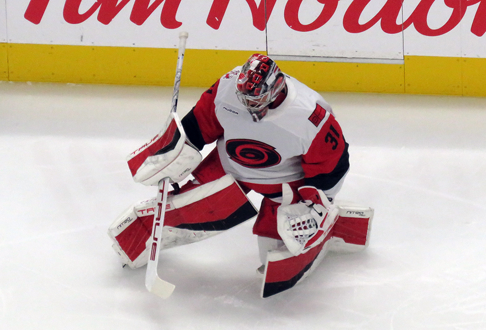 Frederik Andersen of the Carolina Hurricanes stretches during pre-game warmups before a game against the Detroit Red Wings.