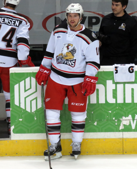 Xavier Ouellet stands at the bench during pre-game warmups before a Grand Rapids Griffins game.