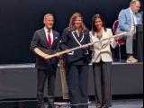 Andrea Brandli is selected fifteenth overall at the 2026 PWHL Entry Draft, flanked by Ilitch Holdings president Chris Ilitch and PWHL Detroit general manager Manon Rheaume.
