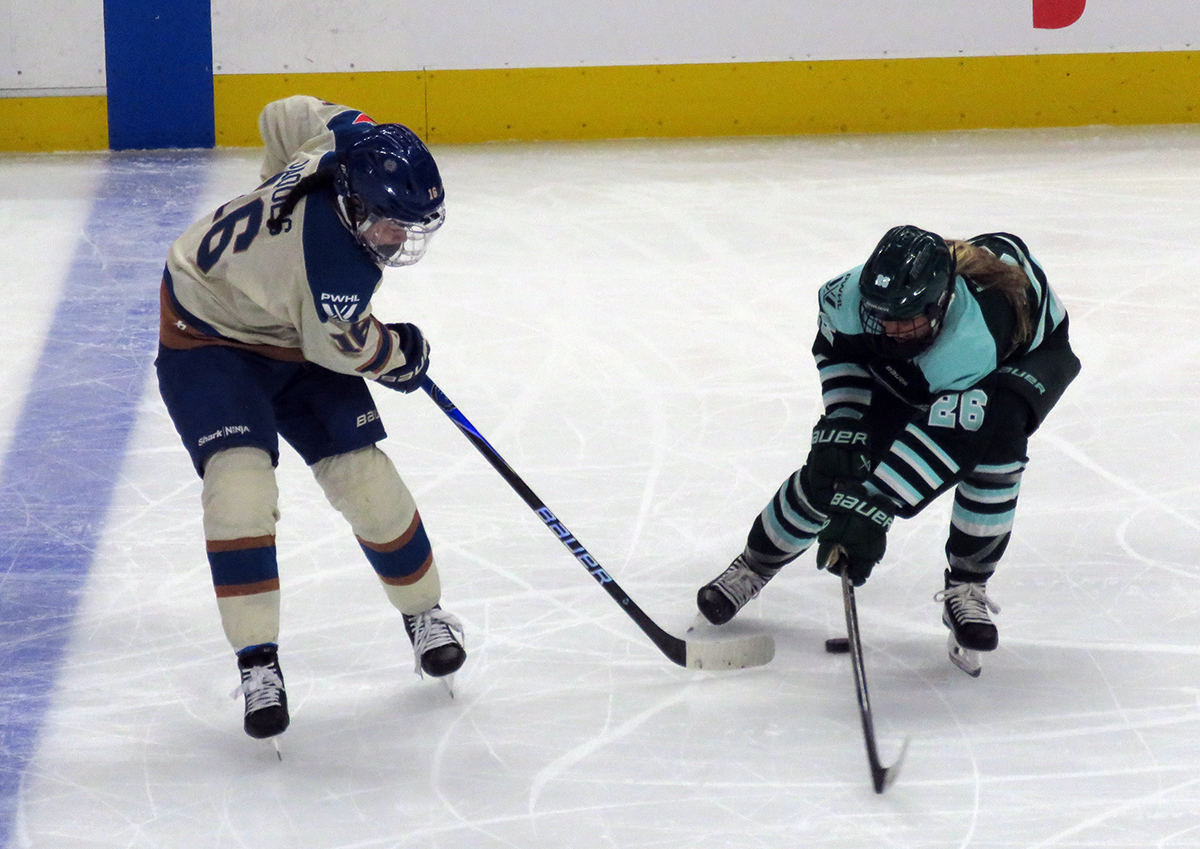 Sophie Jaques of the Vancouver Goldeneyes and Ella Huber of the Boston Fleet fight for the puck during the PWHL Takeover Tour Detroit game.