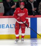 Emmitt Finnie of the Detroit Red Wings stands at the bench during pre-game warmups before a game against the Carolina Hurricanes, wearing a customized Sergei Fedorov jersey and white skates in honor of Fedorov's jersey retirement.