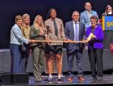 Laila Edwards is selected fourth overall at the 2026 PWHL Entry Draft, flanked by PWHL San Jose general manager Troy Ryan and members of the PWHL leadership team.