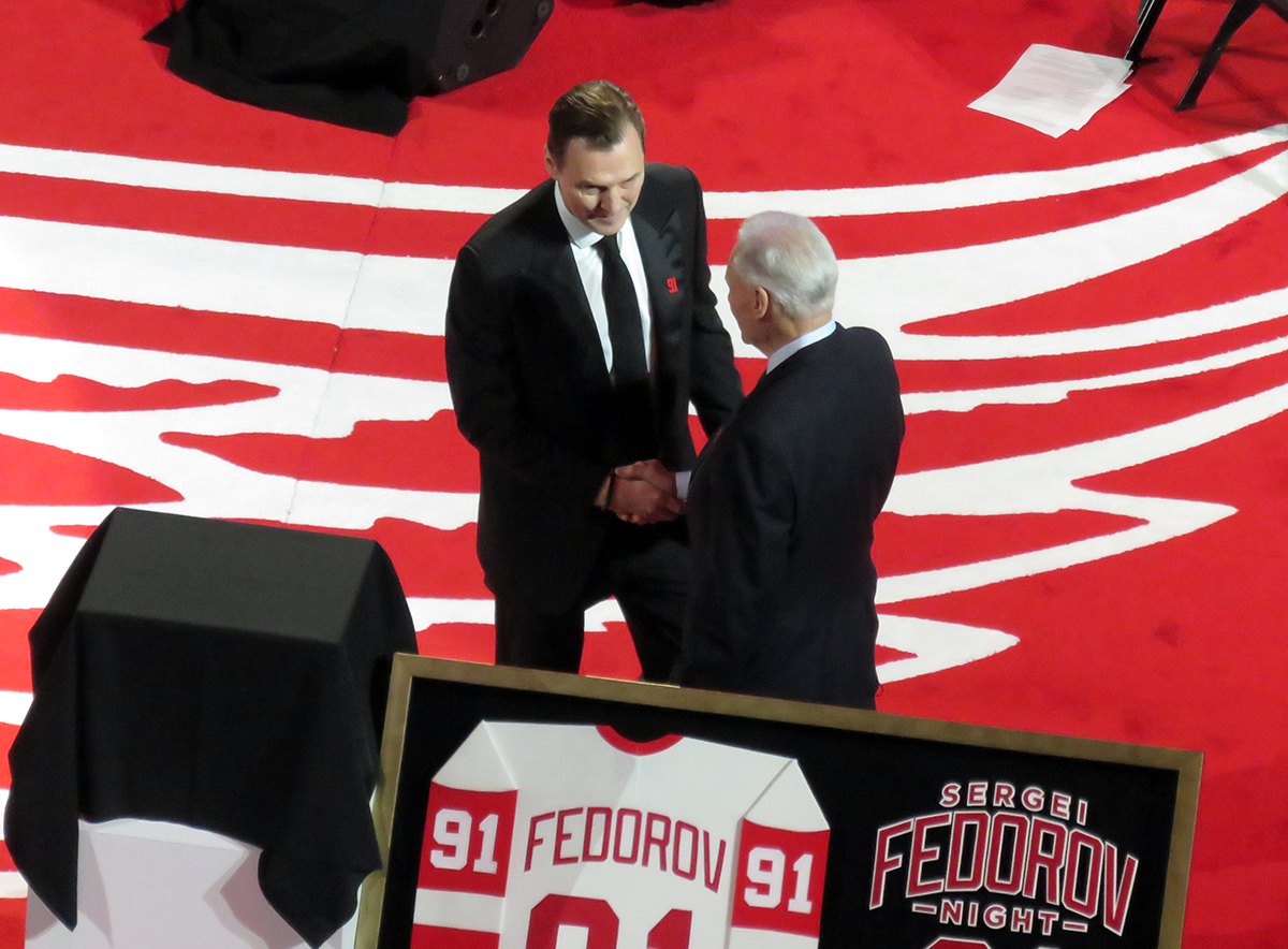 Sergei Fedorov and Mickey Redmond shake hands at Fedorov's jersey retirement ceremony.