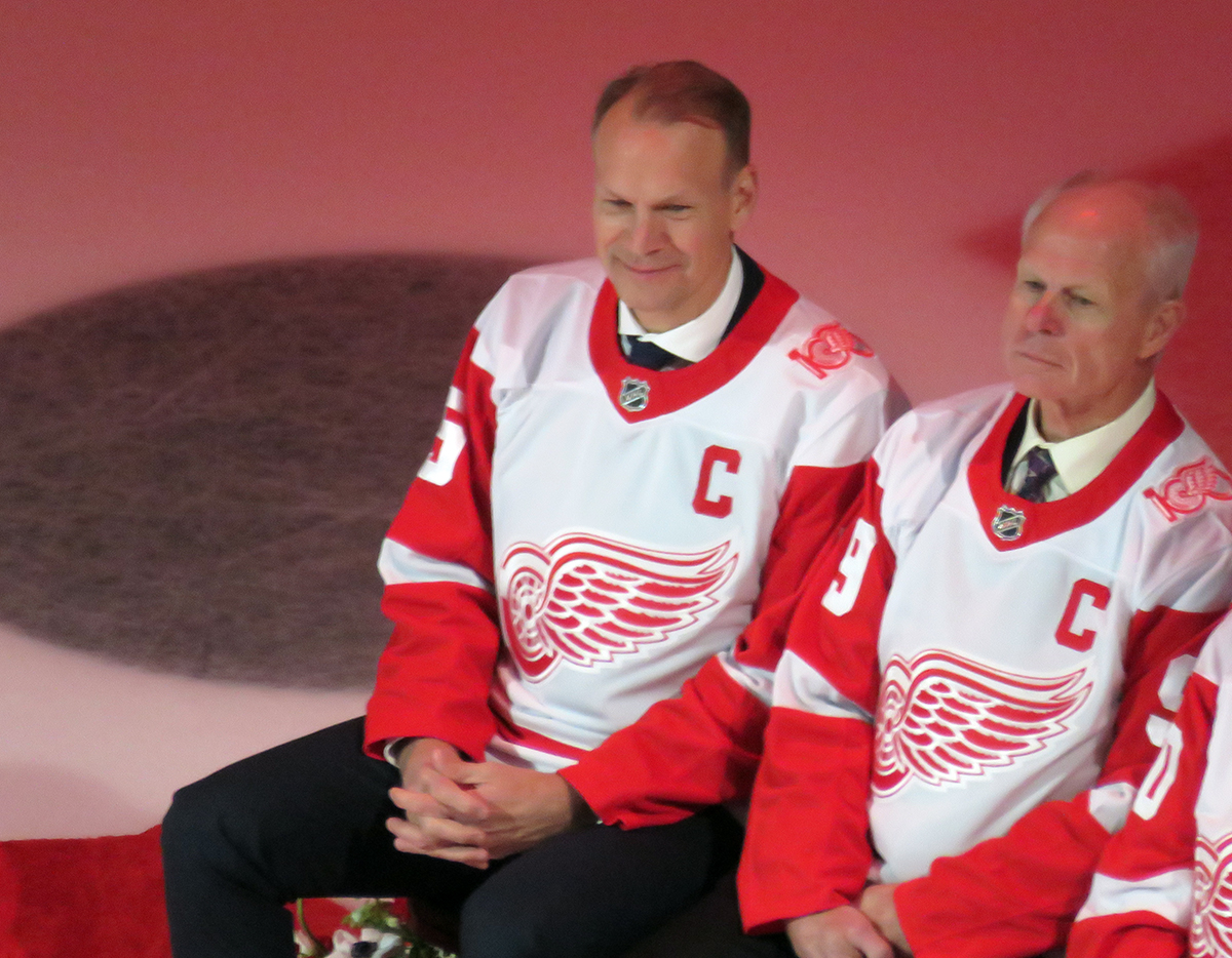 Nicklas Lidstrom and Mark Howe watch Sergei Fedorov speak during Fedorov's jersey retirement ceremony.