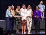 Caroline Harvey is selected first overall at the 2026 PWHL Entry Draft, flanked by Vancouver Goldeneyes general manager Cara Gardner Morey and members of the PWHL leadership team.