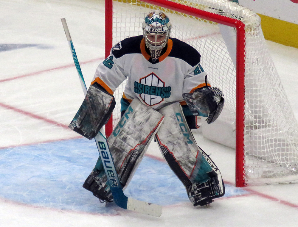 Kayle Osborne of the New York Sirens gets set in her crease during the PWHL Takeover Tour Detroit game against the Montreal Victoire.