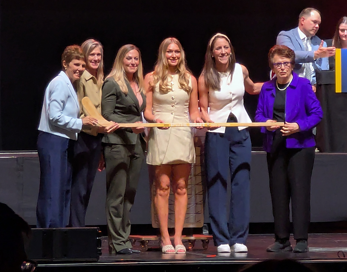 Nelli Laitinen is selected sixth overall at the 2026 PWHL Entry Draft, flanked by PWHL Hamilton general manager Meghan Duggan and members of the PWHL leadership team.