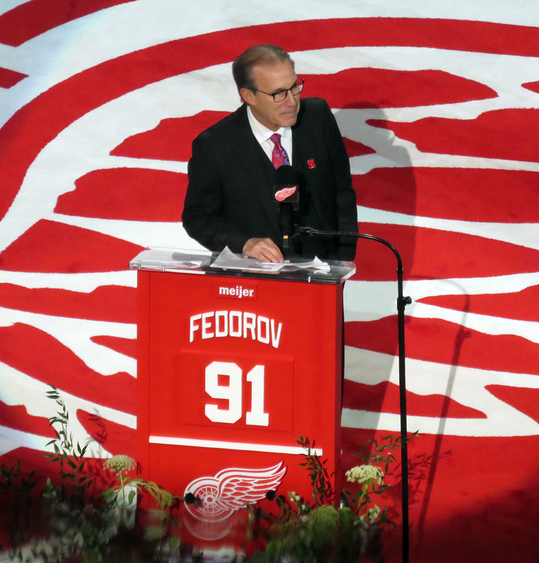 Ken Daniels stands at the podium during Sergei Fedorov's jersey retirement ceremony.