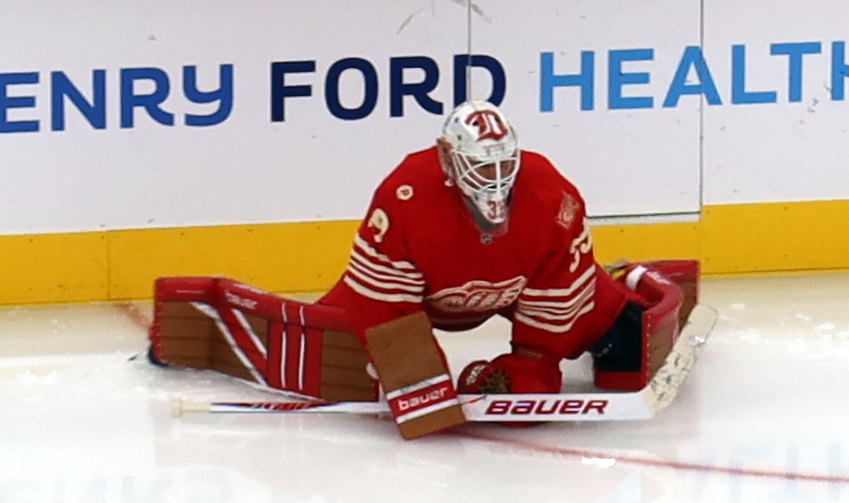 Cam Talbot of the Detroit Red Wings stretches near the boards during pre-game warmups before a game against the Montreal Canadiens.
