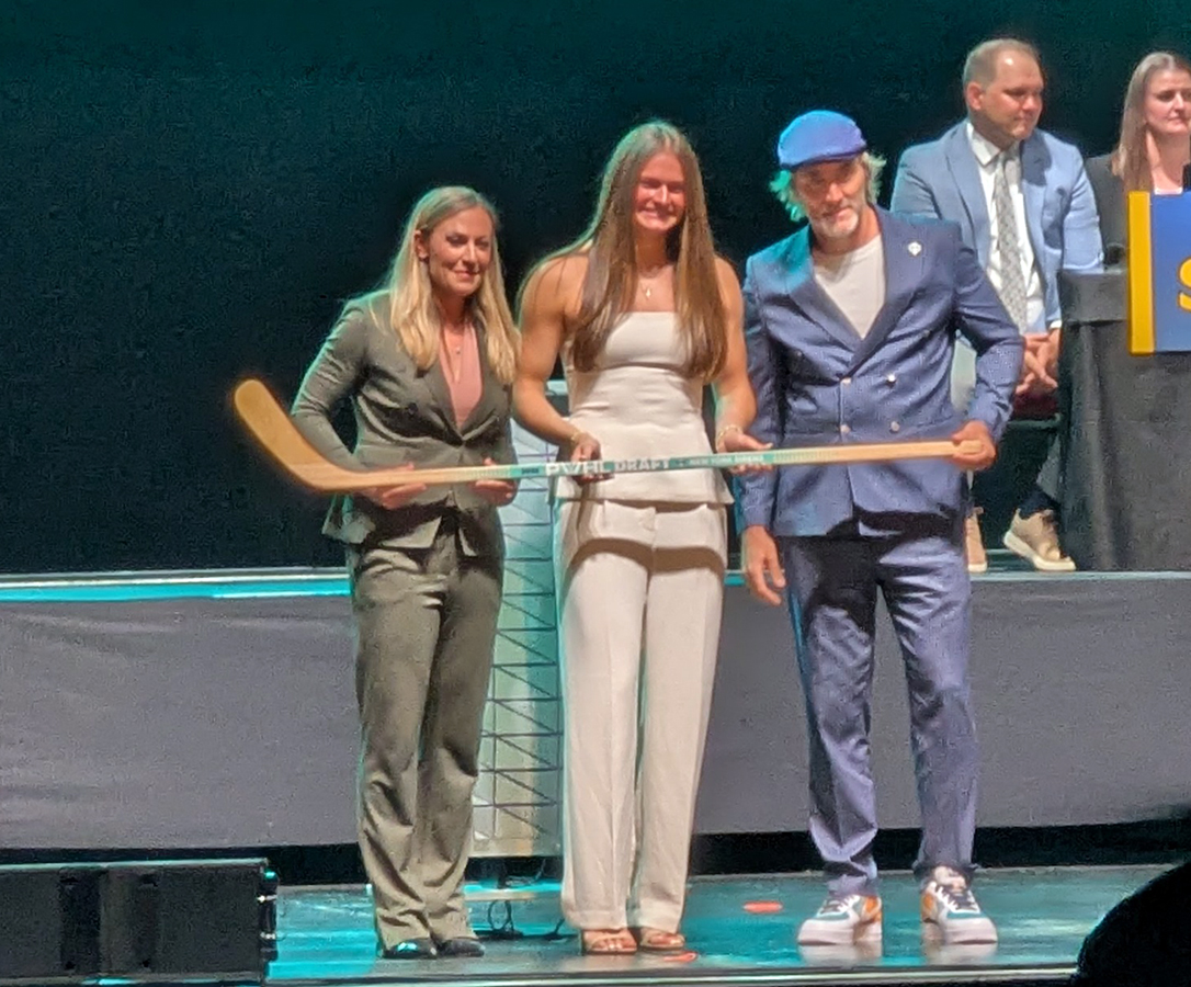 Emma Peschel is selected seventh overall at the 2026 PWHL Entry Draft, flanked by PWHL senior vice president Jayna Hefford and New York Sirens general manager Pascal Daoust.