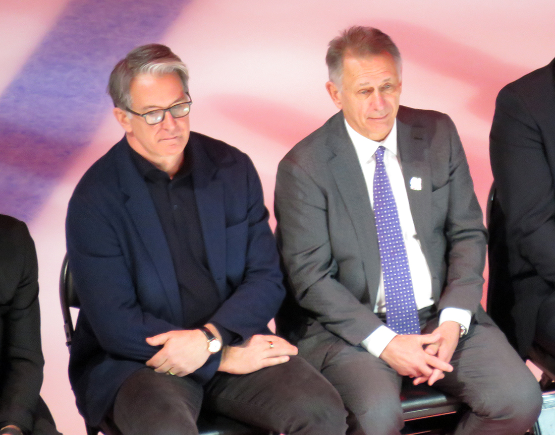 Brendan Shanahan and Ken Holland watch Sergei Fedorov speak during Fedorov's jersey retirement ceremony.