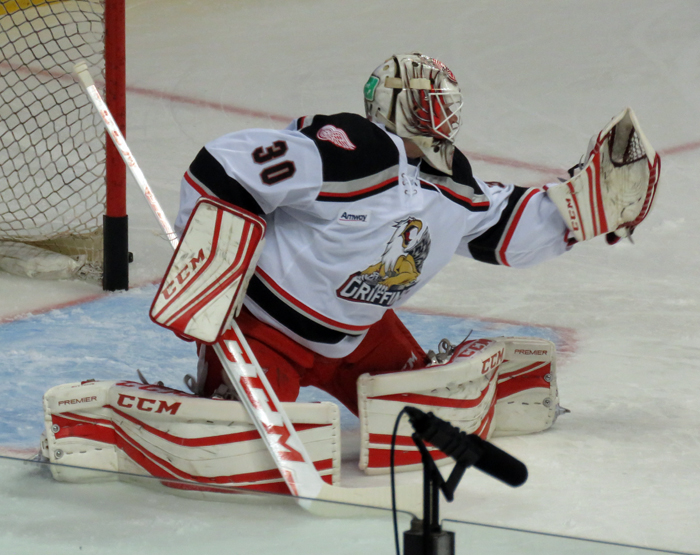 Tom McCollum reaches out for a puck during pre-game warmups before a Grand Rapids Griffins game.