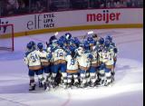 The Vancouver Goldeneyes gather in front of their goal to celebrate a win over the Boston Fleet in the PWHL Takeover Tour Detroit game.