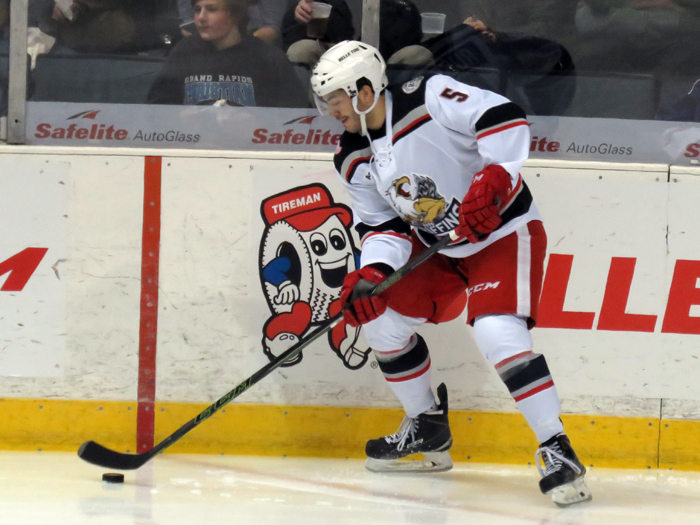 Robbie Russo plays the puck out of the corner during a Grand Rapids Griffins game.