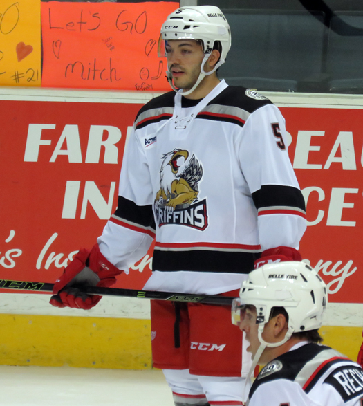 Robbie Russo stands near the boards during pre-game warmups before a Grand Rapids Griffins game.
