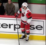 Jordan Martinook of the Carolina Hurricanes stands at the bench during pre-game warmups before a game against the Detroit Red Wings.