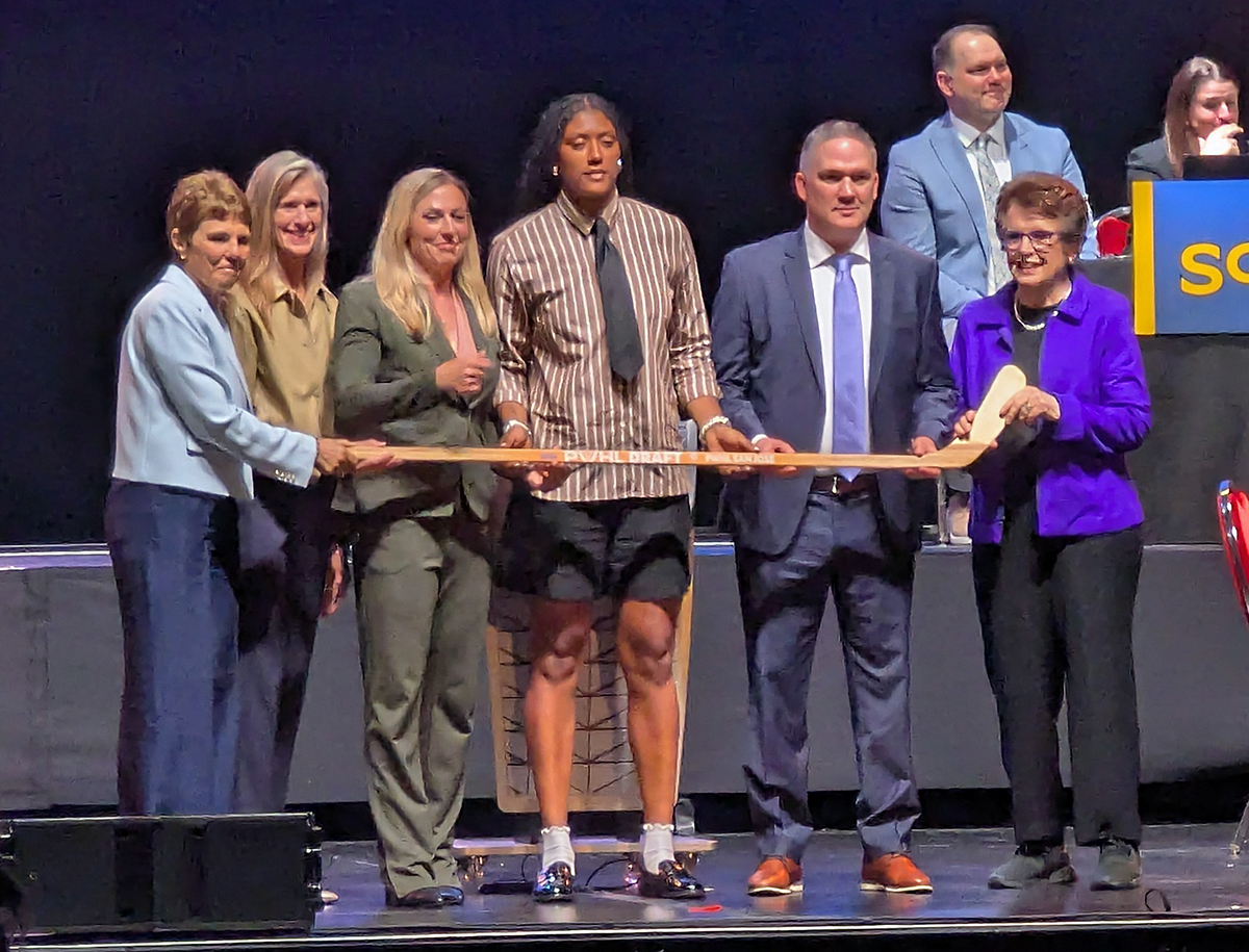Laila Edwards is selected fourth overall at the 2026 PWHL Entry Draft, flanked by PWHL San Jose general manager Troy Ryan and members of the PWHL leadership team.