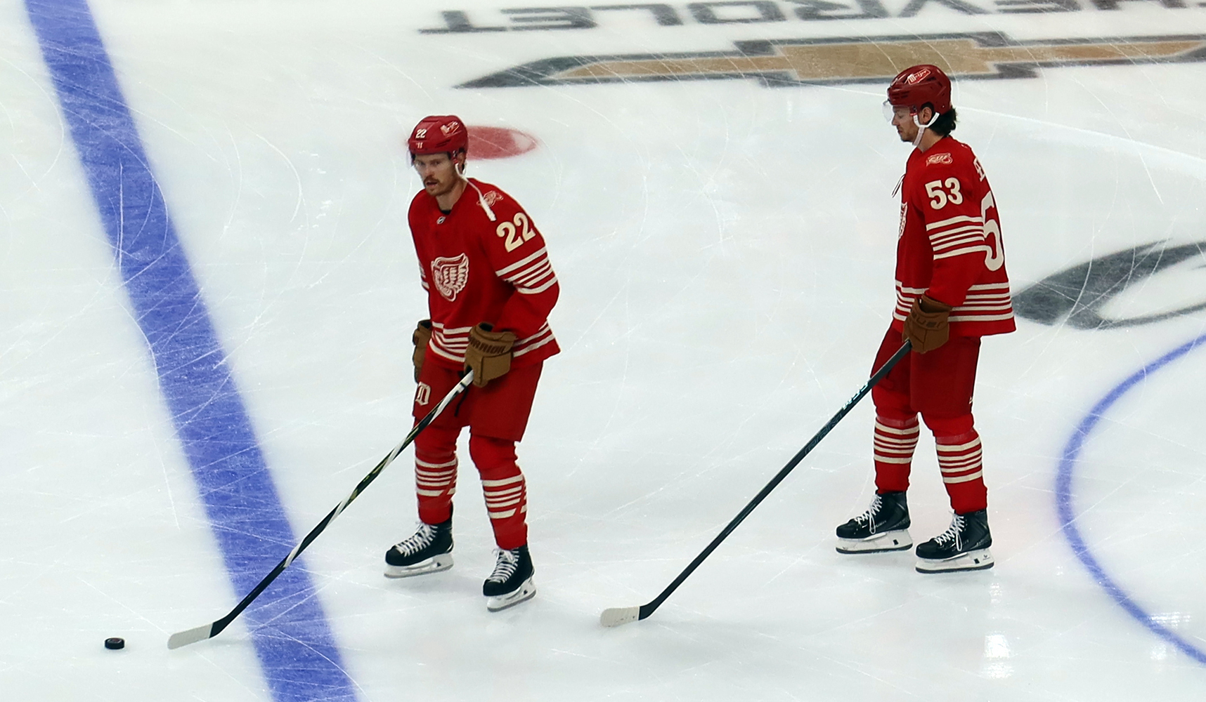 Mason Appleton and Moritz Seider of the Detroit Red Wings skate in the neutral zone during pre-game warmups before a game against the Montreal Canadiens.