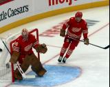 John Gibson of the Detroit Red Wings covers his post while Ben Chiarot skates at the edge of the crease during a game against the Montreal Canadiens.