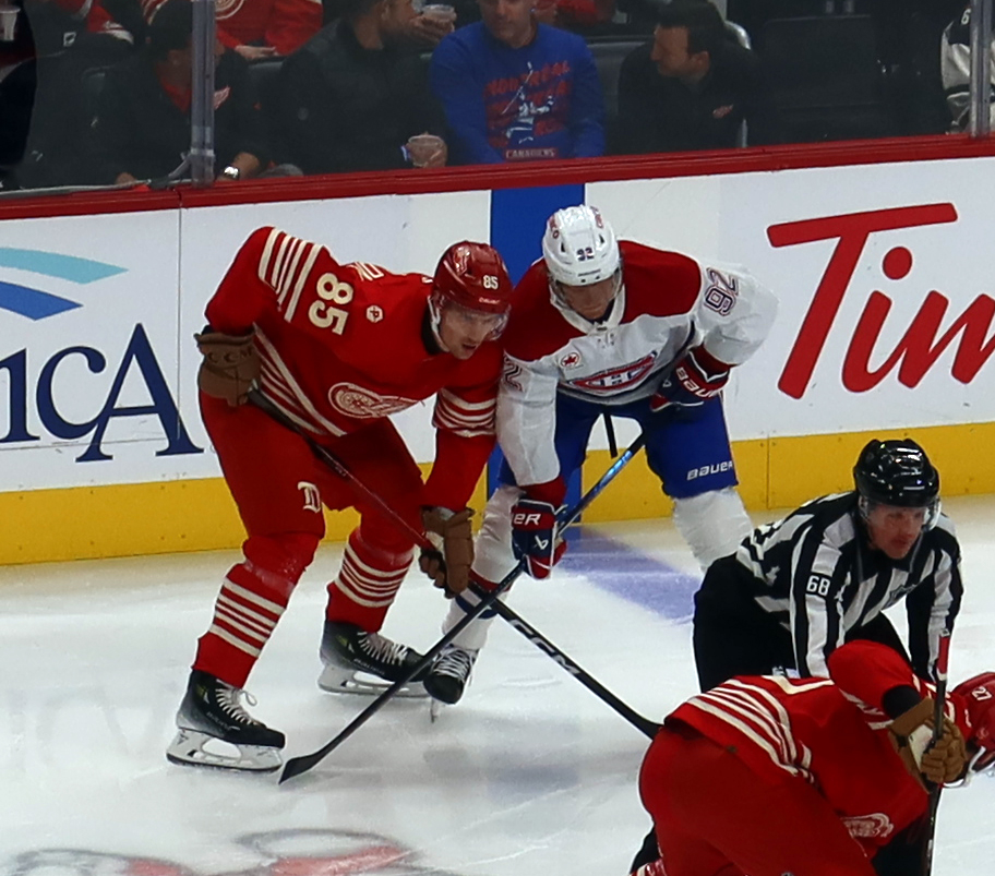 Elmer Soderblom of the Detroit Red Wings lines up at wing for a faceoff opposite Patrik Laine of the Montreal Canadiens.