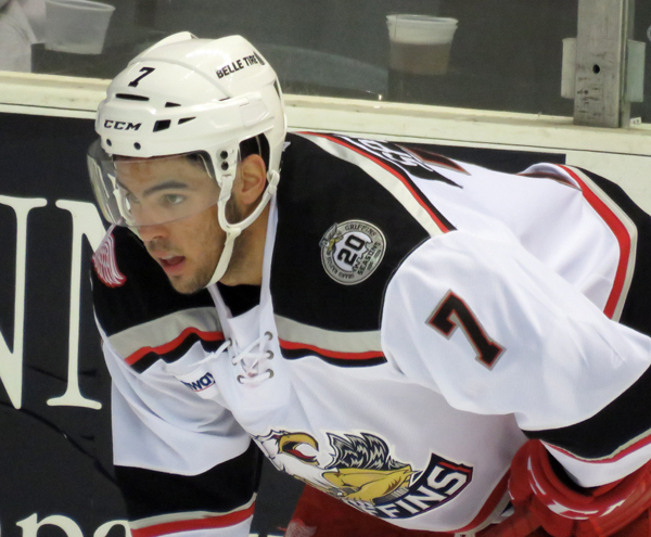Ryan Sproul crouches near the boards during a stop in play in a Grand Rapids Griffins game.