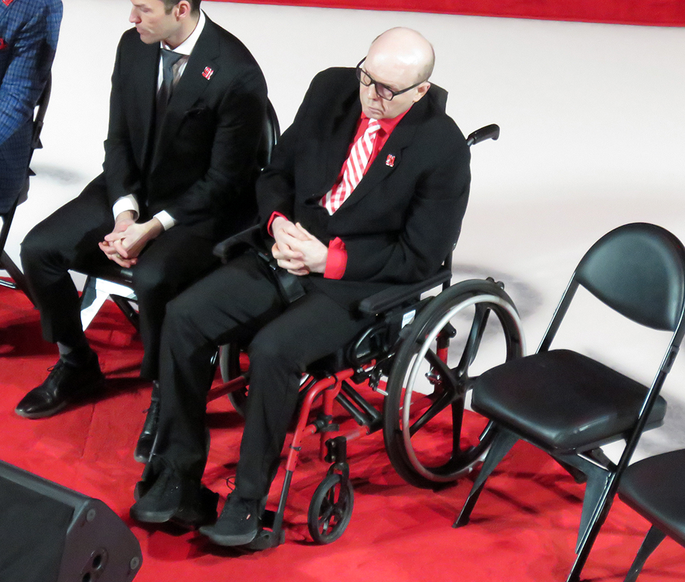 Vladimir Konstantinov sits on the stage at Sergei Fedorov's jersey retirement ceremony.