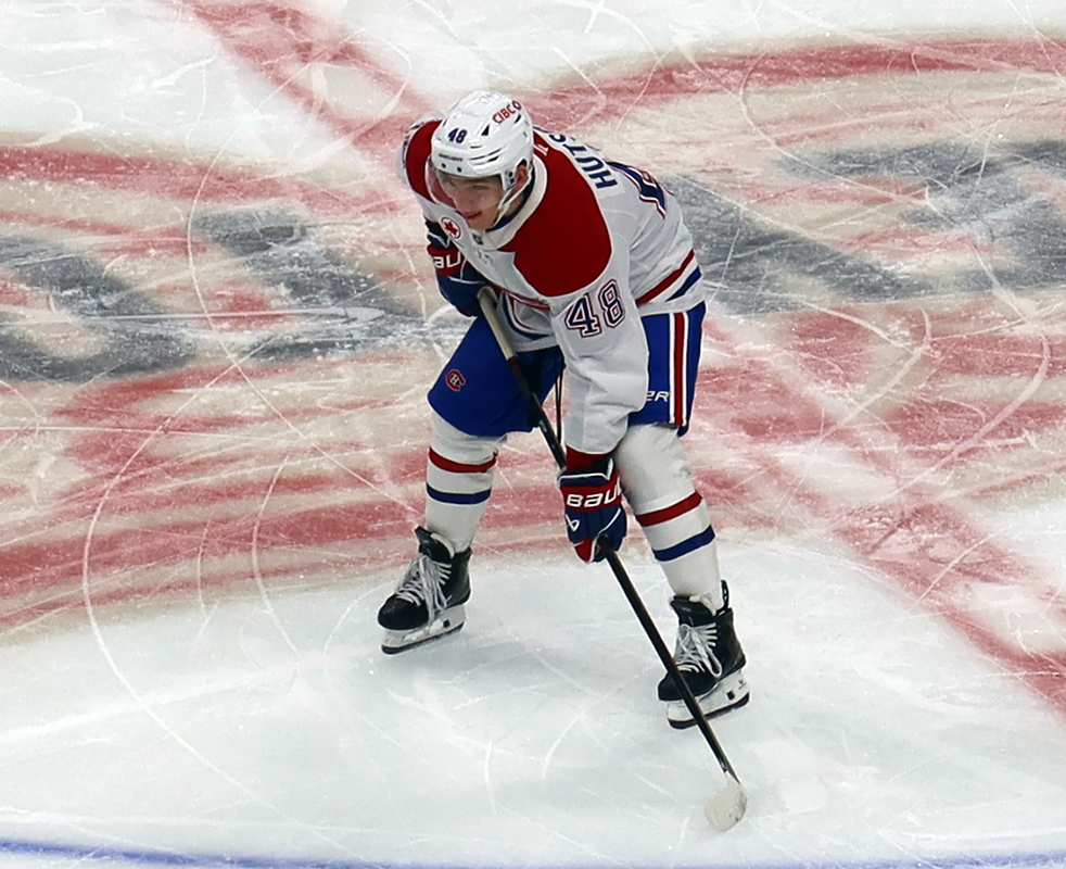 Lane Hutson of the Montreal Canadiens gets set for a faceoff during a game against the Detroit Red Wings.