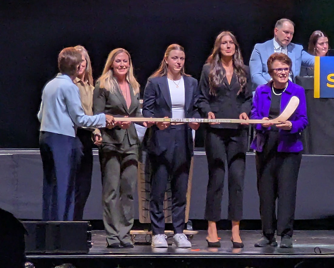 Tessa Janecke is selected third overall at the 2026 PWHL Entry Draft, flanked by PWHL Las Vegas general manager Dominique Didia and members of the PWHL leadership team.