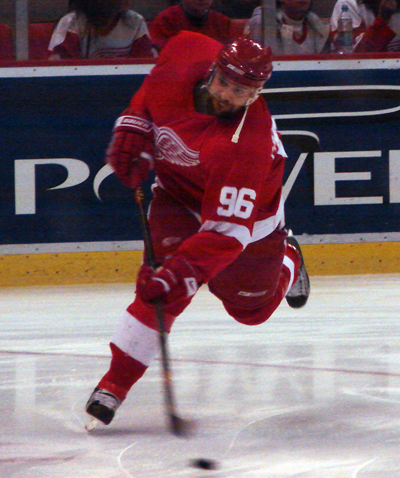 Tomas Holmstrom leans into a shot during pregame warmups.