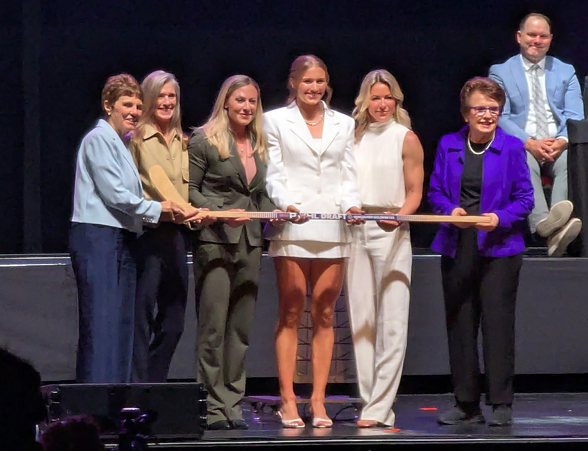 Caroline Harvey is selected first overall at the 2026 PWHL Entry Draft, flanked by Vancouver Goldeneyes general manager Cara Gardner Morey and members of the PWHL leadership team.