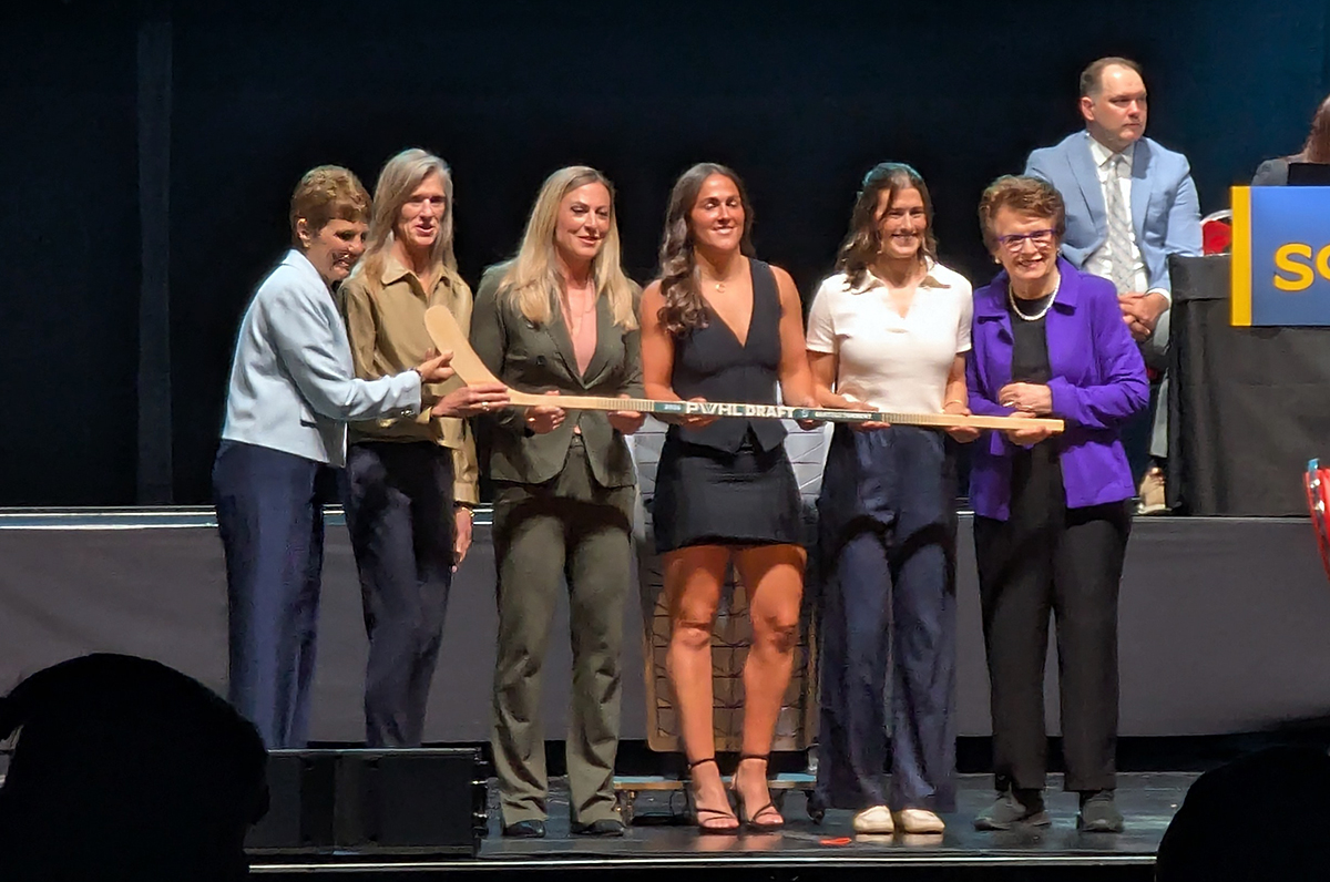 Abbey Murphy is selected second overall at the 2026 PWHL Entry Draft, flanked by Seattle Torrent general manager Meghan Turner and members of the PWHL leadership team.