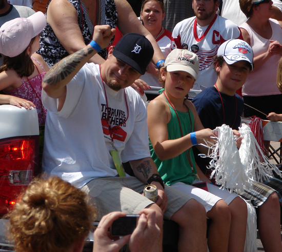 Darren McCarty pumps a fist to the crowd while riding on the tailgate of a truck during the 2008 Stanley Cup parade.