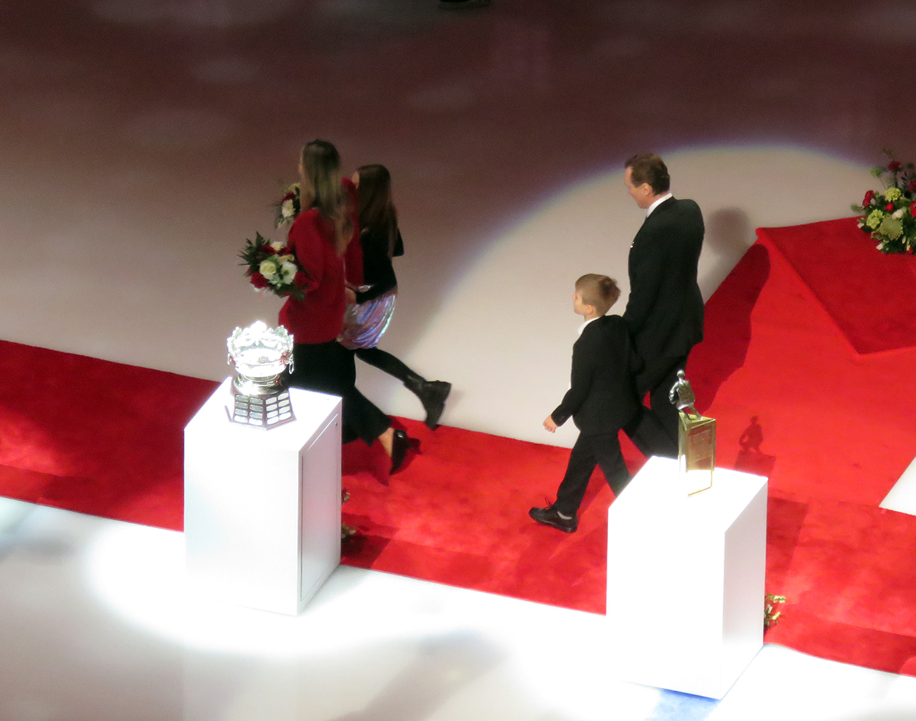 Sergei Fedorov and his family walk past some of the trophies he won over his career during his jersey retirement ceremony.