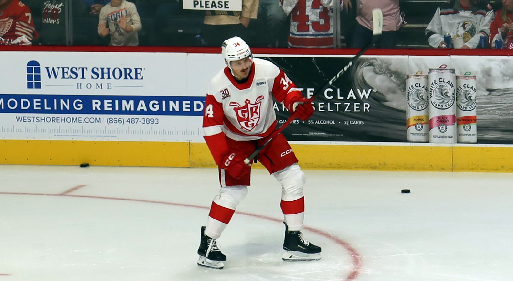 Eduards Tralmaks of the Grand Rapids Griffins winds up for a shot during pre-game warmups before a game against the Manitoba Moose.