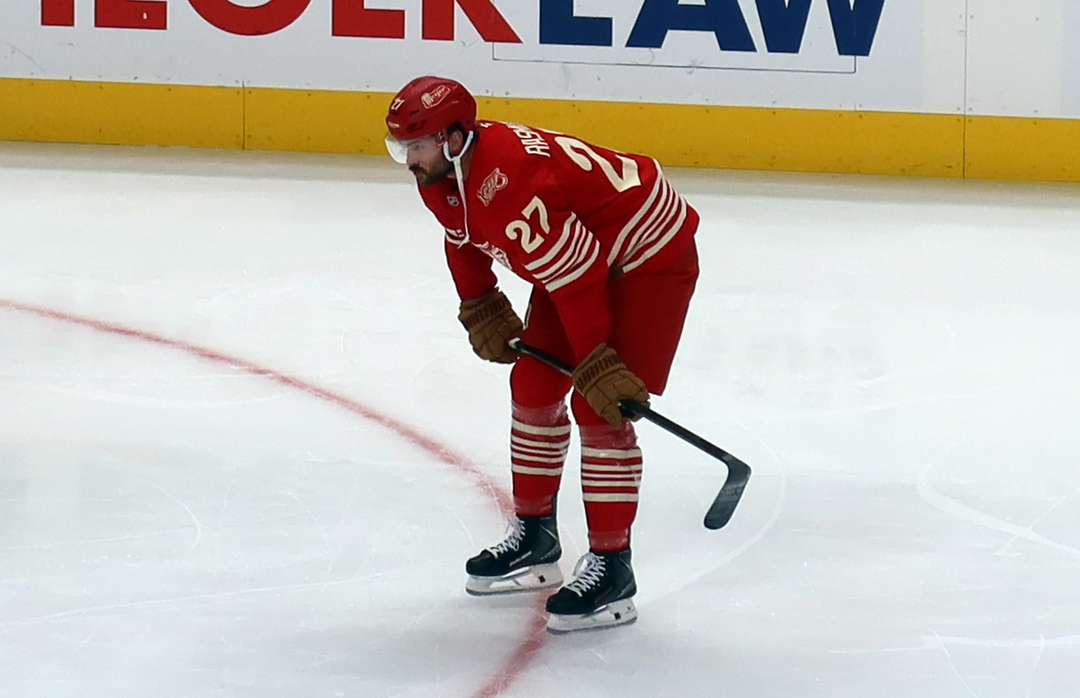 Michael Rasmussen of the Detroit Red Wings crouches near the boards during pre-game warmups before a game against the Montreal Canadiens.