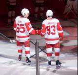 Dominik Shine and Amadeus Lombardi of the Grand Rapids Griffins give each other a fist bump during player introductions before the team's home opener against the Manitoba Moose.
