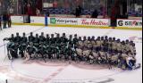 The Boston Fleet and Vancouver Goldeneyes pose at center ice for a group photo after the PWHL Takeover Tour Detroit game.