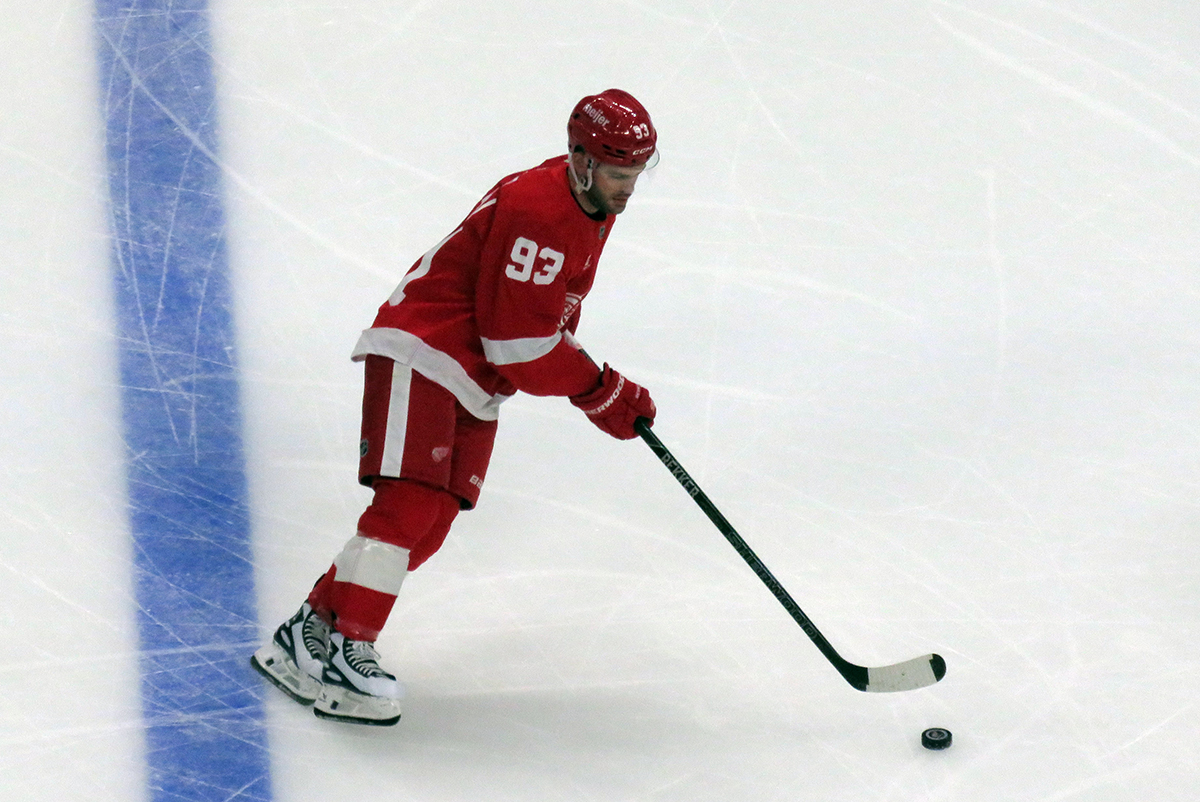 Alex DeBrincat of the Detroit Red Wings skates during pre-game warmups before a game against the Carolina Hurricanes, wearing a customized Sergei Fedorov jersey and white skates in honor of Fedorov's jersey retirement.
