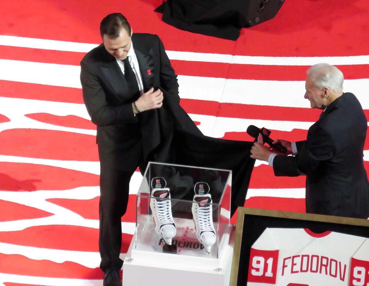 Sergei Fedorov and Mickey Redmond unveil a commemorative pair of Fedorov's signature white skates during Fedorov's jersey retirement ceremony.