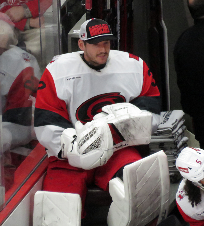 Carolina Hurricanes' backup goalie Brandon Bussi sits at the bench during a game against the Detroit Red Wings.