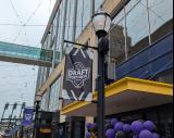A banner celebrating the 2026 PWHL Entry Draft hangs on Columbia Street next to the Fox Theater.