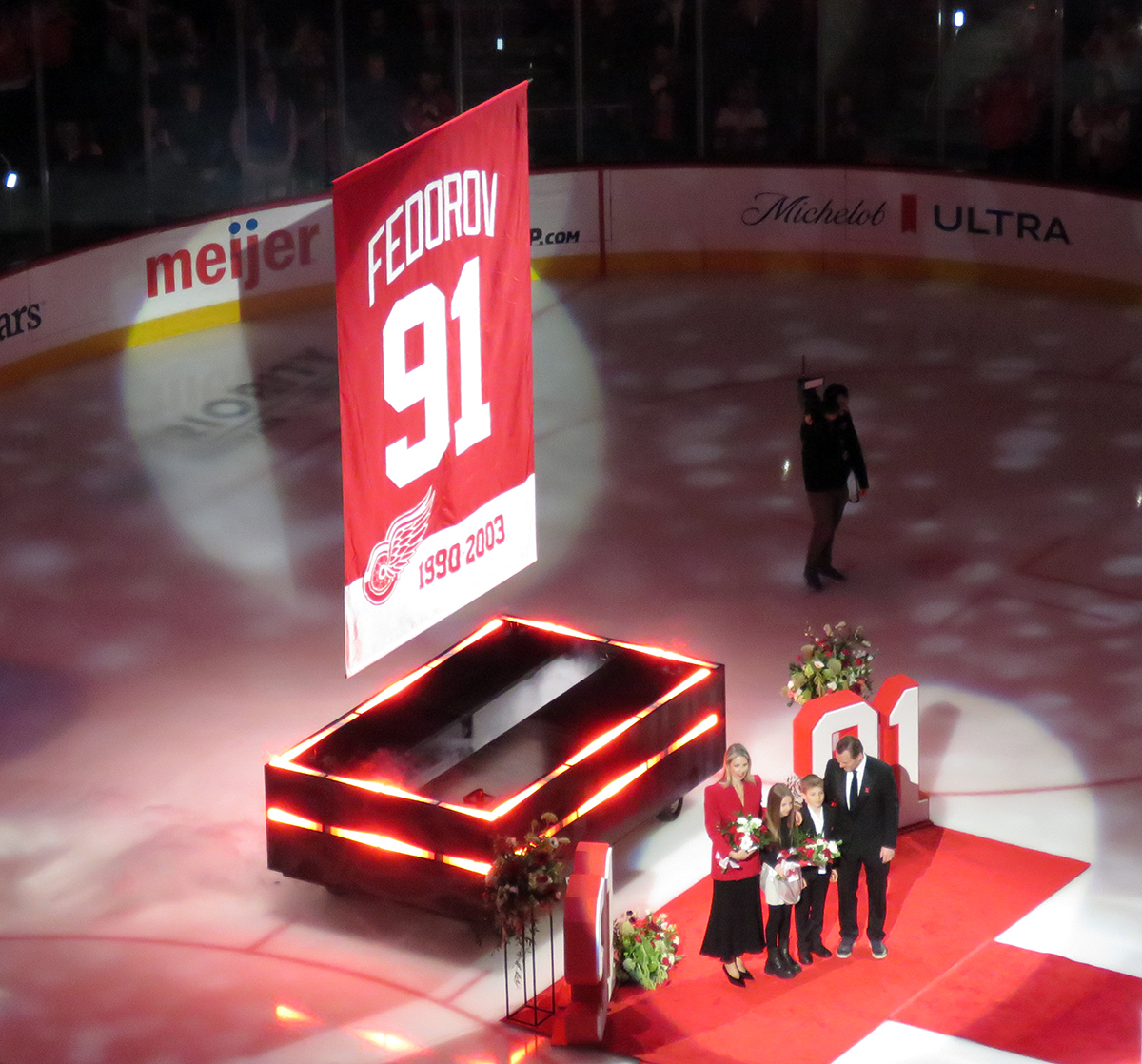 Sergei Fedorov and his family pose in front of his newly-unveiled retired jersey banner.