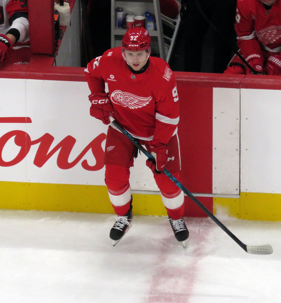 Marco Kasper of the Detroit Red Wings skates near the boards during a game against the Carolina Hurricanes.