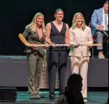 Grace Dwyer is selected tenth overall at the 2026 PWHL Entry Draft, flanked by PWHL senior vice president Jayna Hefford and Boston Fleet general manager Danielle Marmer.