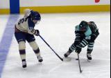 Sophie Jaques of the Vancouver Goldeneyes and Ella Huber of the Boston Fleet fight for the puck during the PWHL Takeover Tour Detroit game.