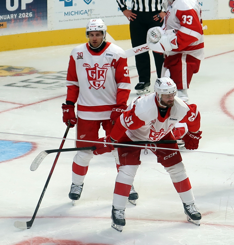 William Lagesson and Austin Watson of the Grand Rapids Griffins get ready for a faceoff during a game against the Manitoba Moose.