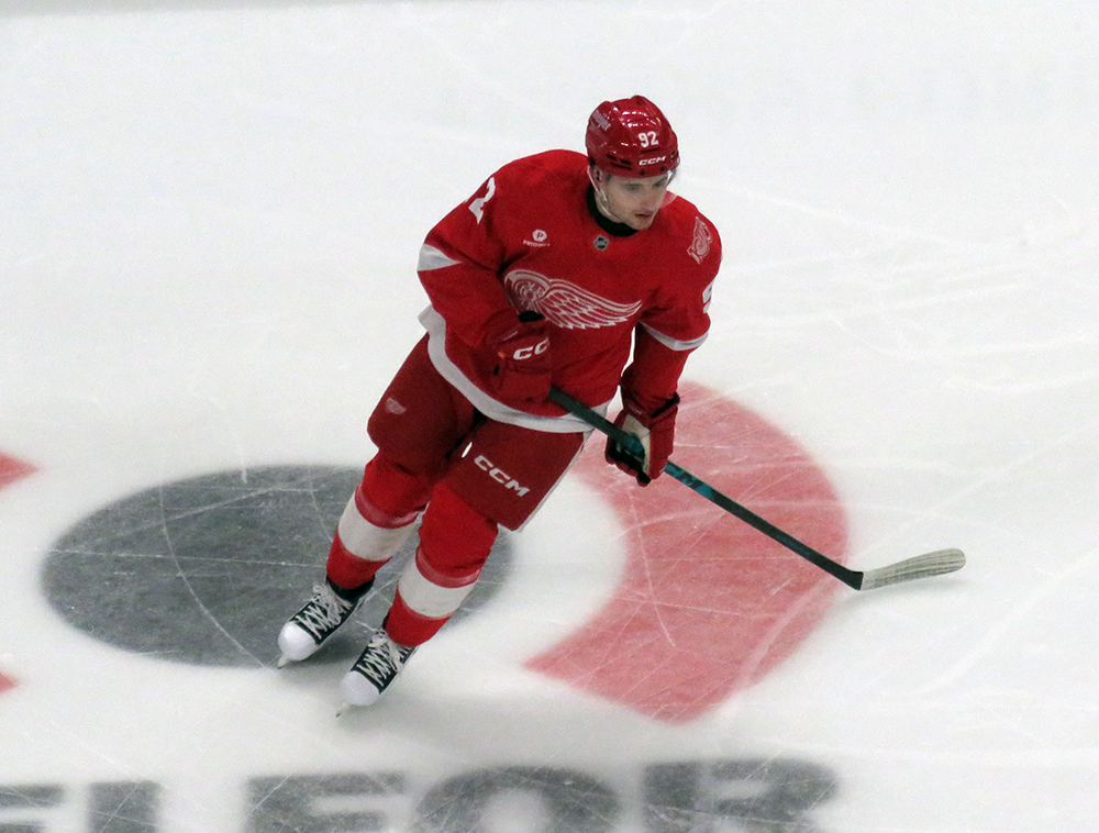 Marco Kasper of the Detroit Red Wings skates in the neutral zone during pre-game warmups before a game against the Carolina Hurricanes, wearing a customized Sergei Fedorov jersey and white skates in honor of Fedorov's jersey retirement.