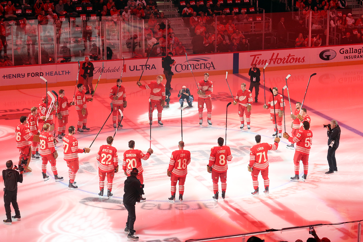 The Detroit Red Wings salute their fans from center ice after player introductions at the start of their home opener.