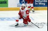 Carson Bantle of the Grand Rapids Griffins kneels near the boards during pre-game warmups before a game against the Manitoba Moose.